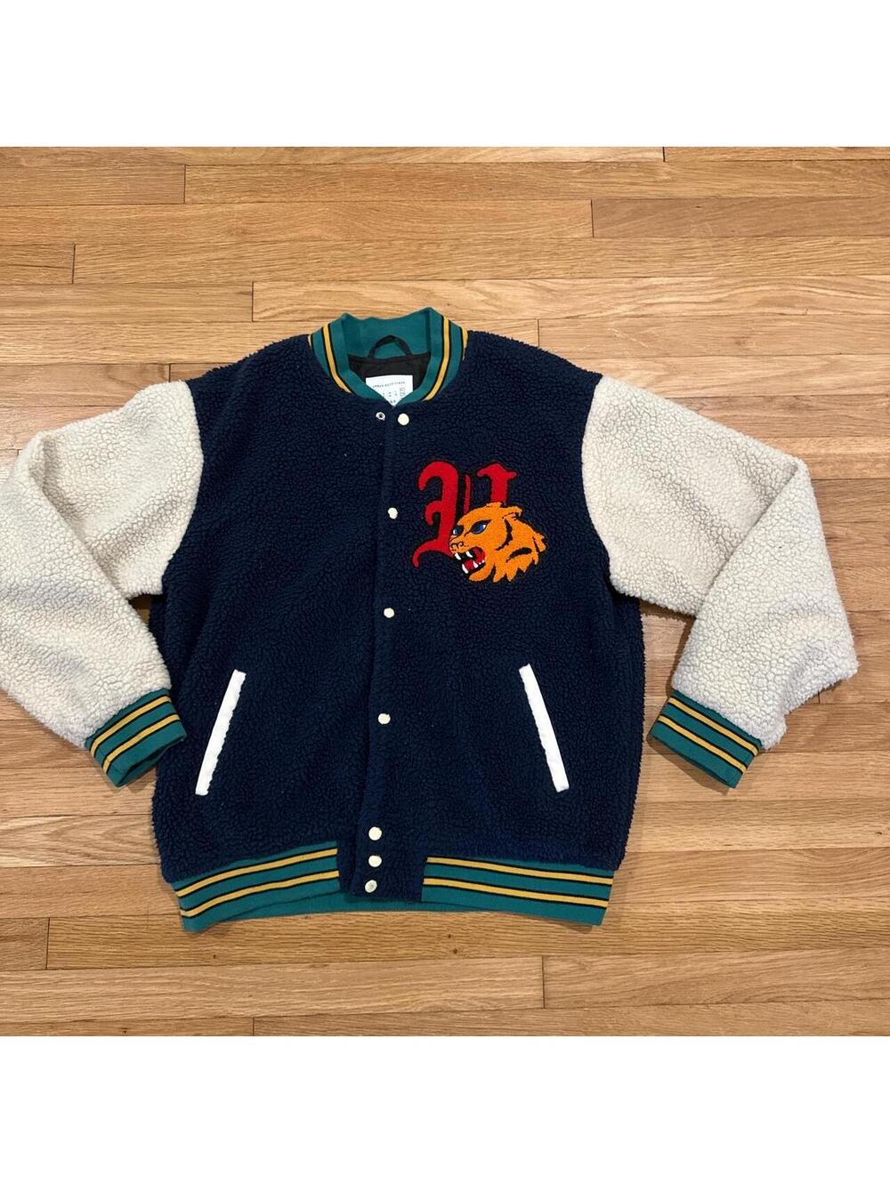 Navy blue varsity jacket with white and green